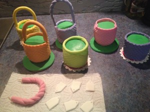 I covered all the baskets in different colours. You could choose a single colour or even use chocolate fondant, leaving the colour to come from the flowers, bows and eggs.